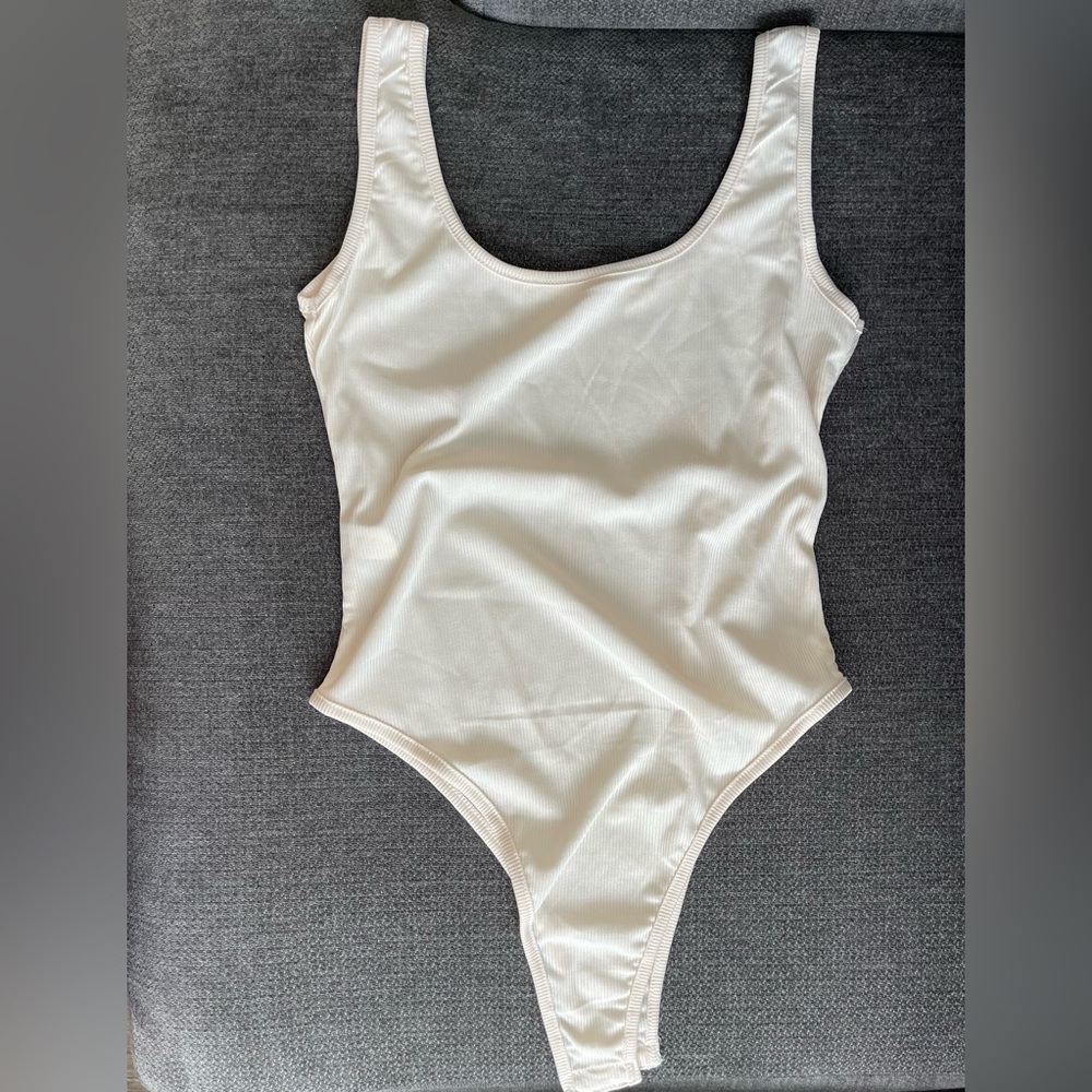 Ribbed Cream bodysuit. NWOT.